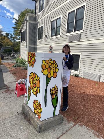 Mary Grassi at her painted utility box